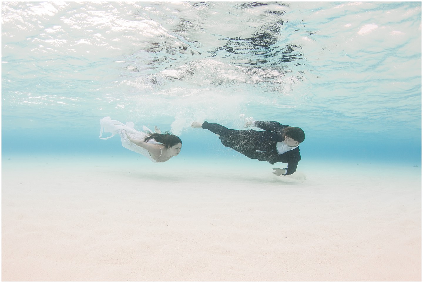 Bride & Groom swim underwaterwater in Fiji