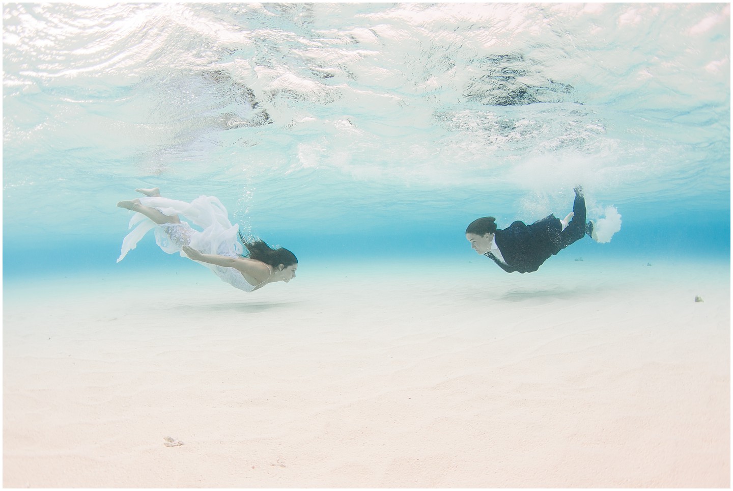 Bride & Groom swim underwaterwater in Fiji water